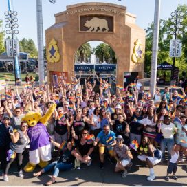 large crowd posing at fair entrance