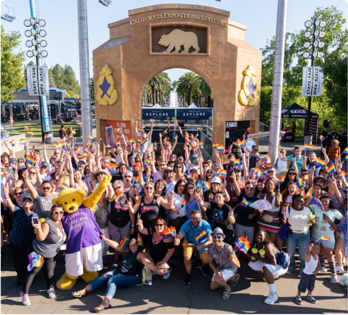 large crowd posing at fair entrance