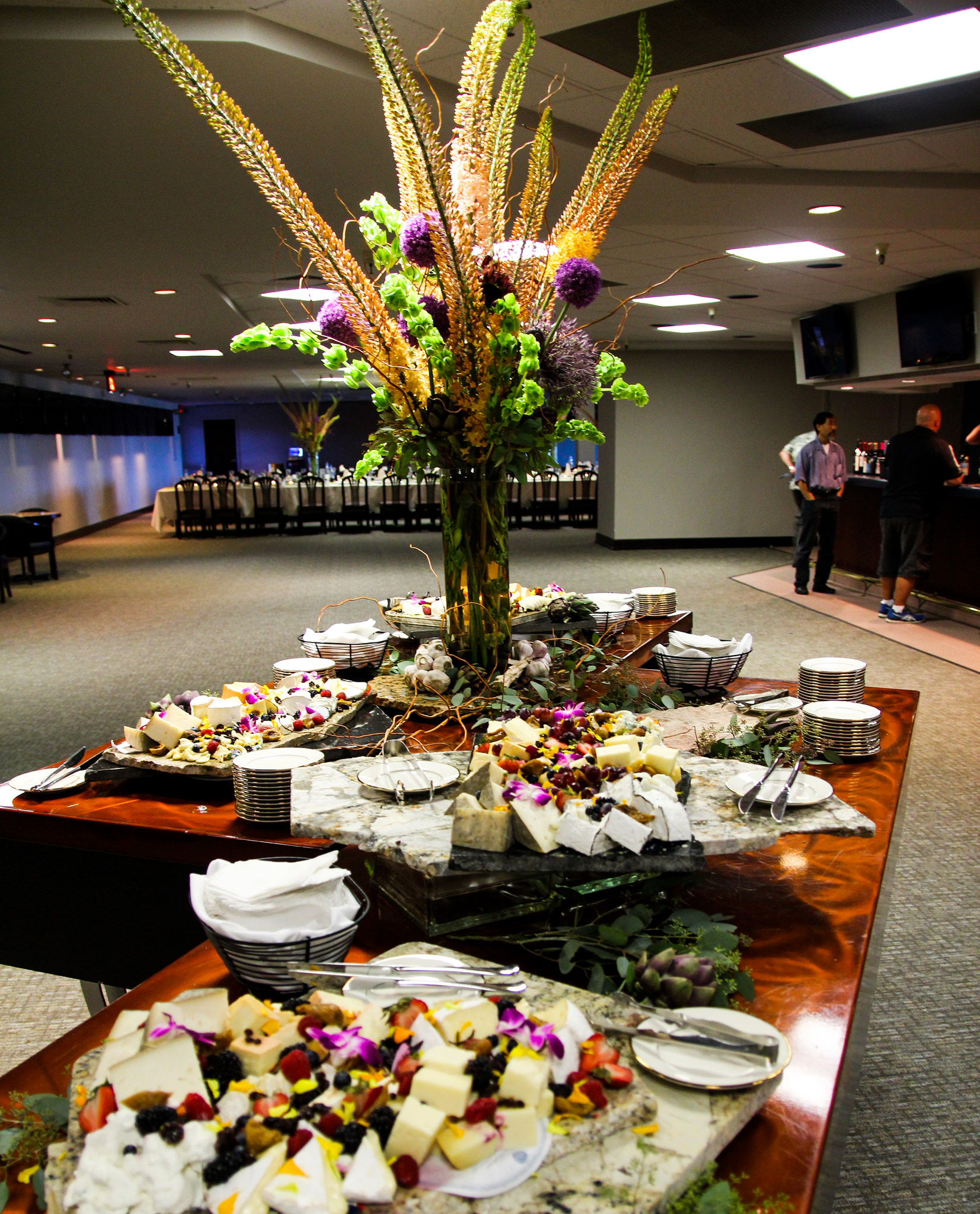 Large table of food and large flower arrangement