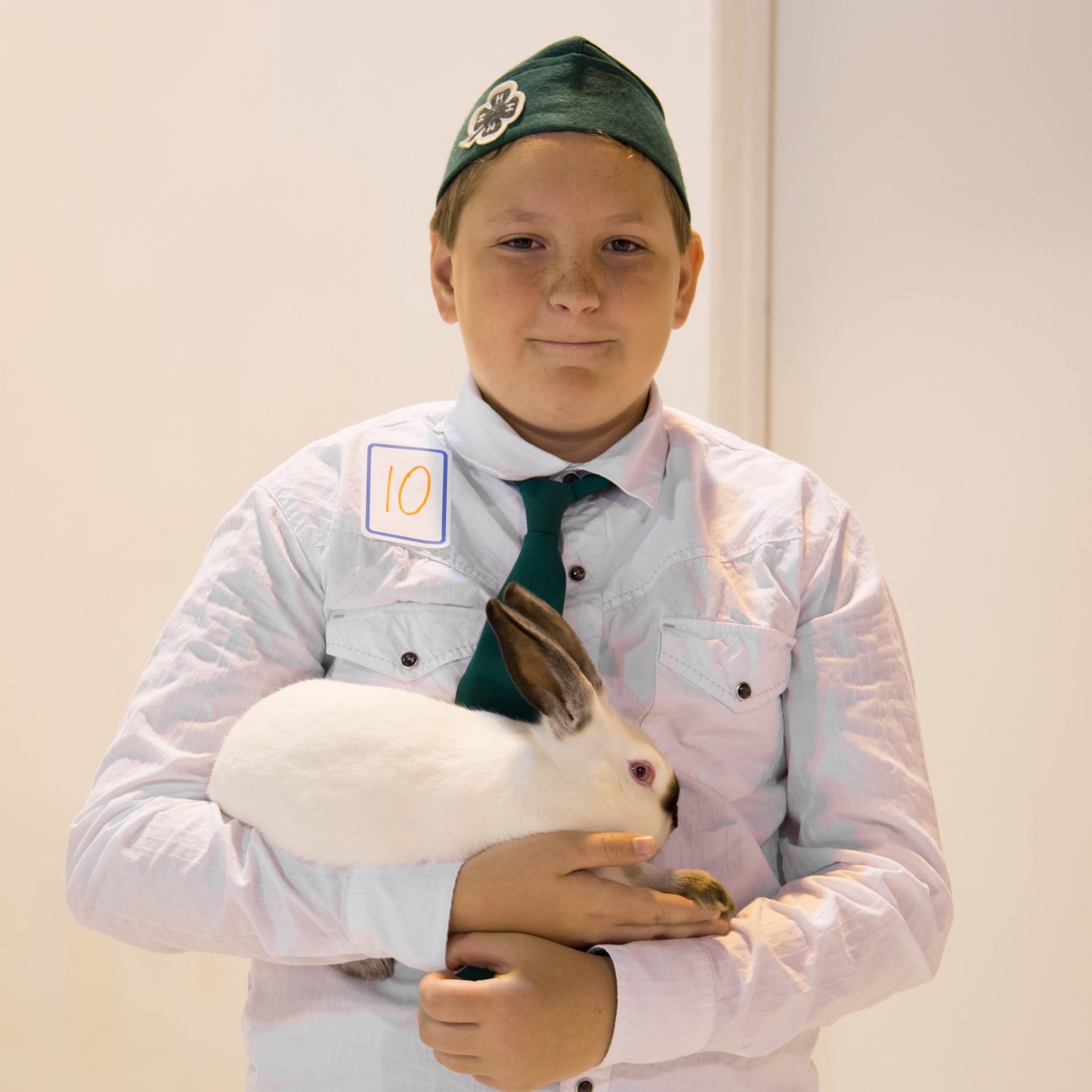 A young boy holding a rabbit