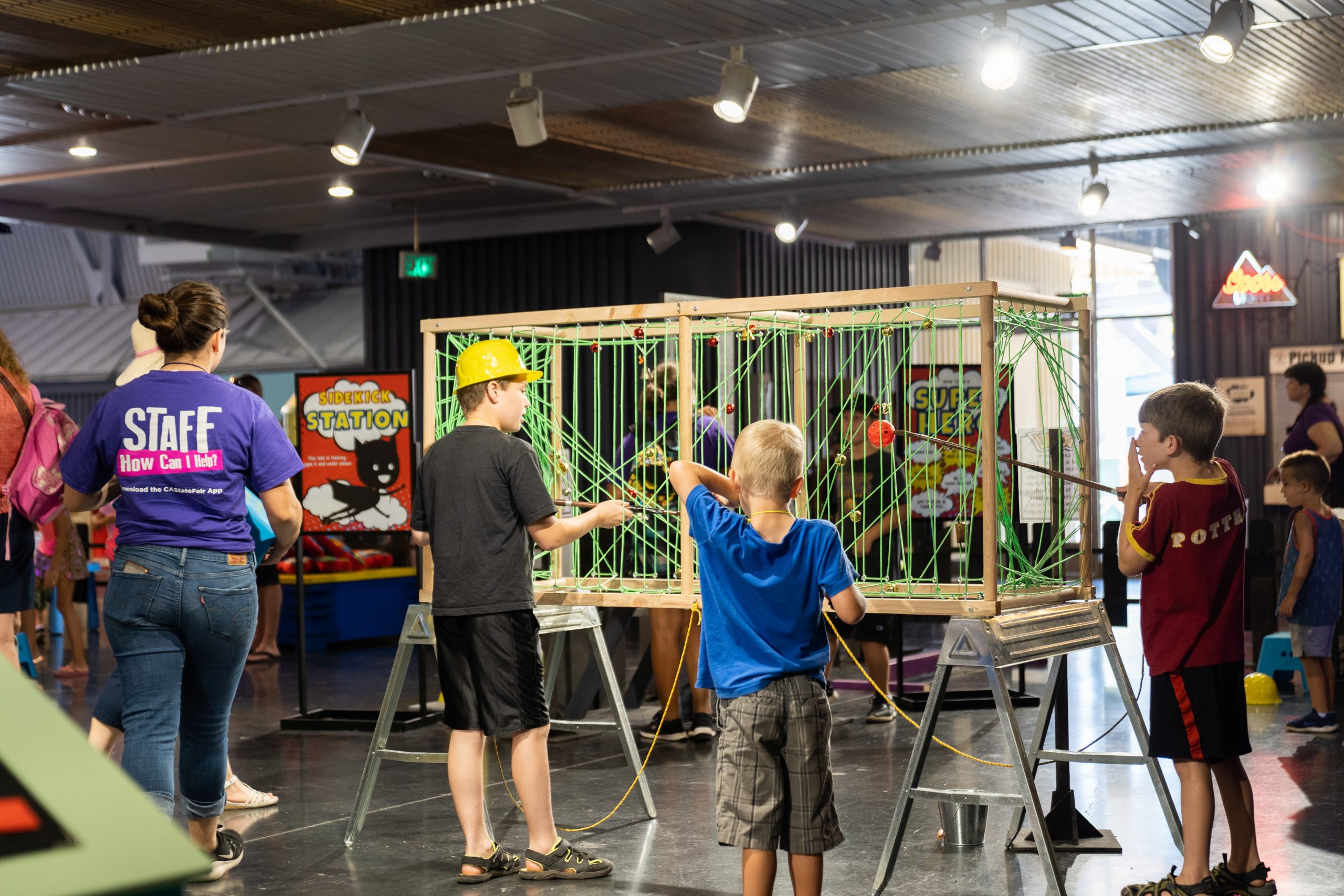 Two boys playing with exhibit game